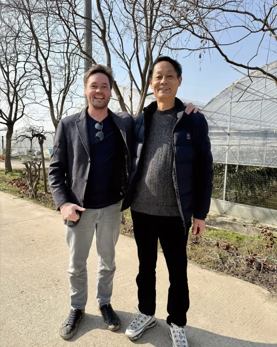 Founder with a morel grower outside cultivation houses
